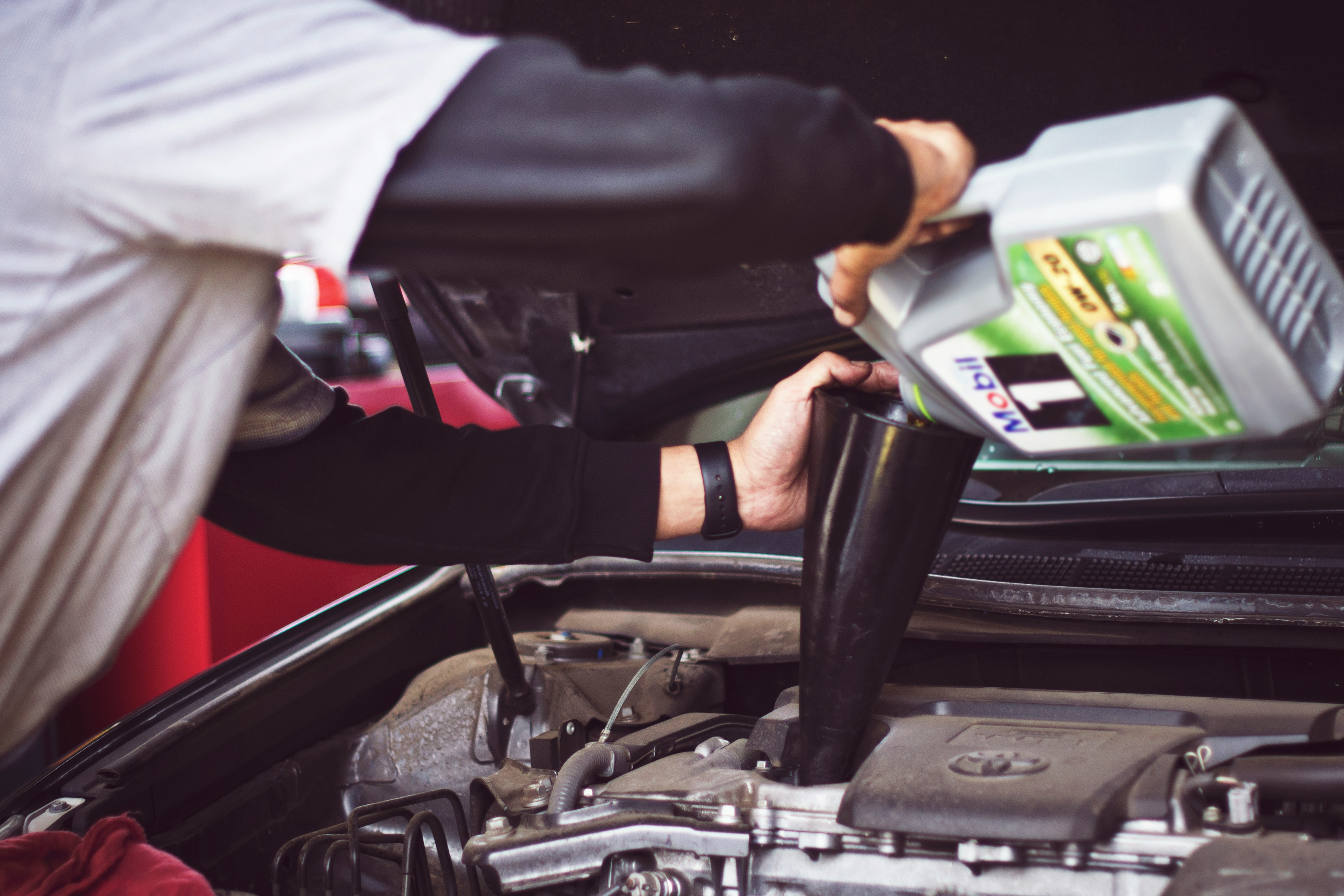 Pouring fresh engine oil during a service